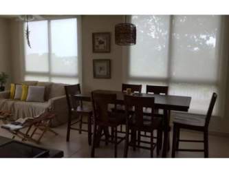 Master bedroom with large windows, access to terrace, ocean view La Ensenada Beach condo Panama