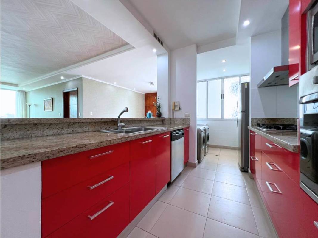 Open kitchen area with granite countertops red cabinets appliances in PH MET San Francisco