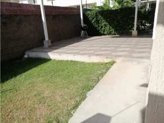 Covered patio area with hedge, lawn and privacy wall at PH Paraiso Village Coronado