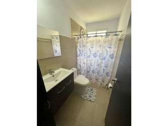 Bathroom featuring tiled floors, sink vanity, shower with curtain in Coronado beach house