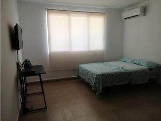 Bedroom with tile floors, large window, and minimalist decor in PH Paraiso Village Coronado Panama