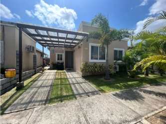 Contemporary one-story beach house with carport and landscaped yard in Coronado Panama