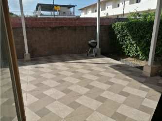 Covered backyard patio with barbecue area in Coronado beach house for sale