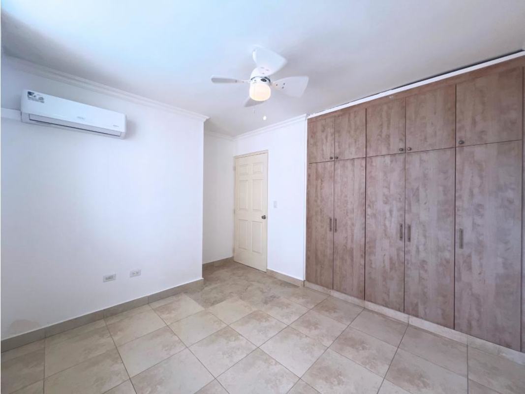 Bright bedroom with tile floor, built-in wardrobe and large windows at PH Portofino Panama