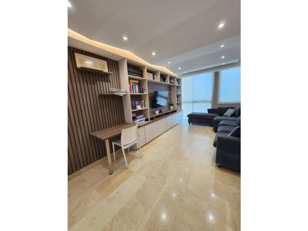 Modern living area with built-in shelving and work nook at PH Vista del Sol apartment for sale Punta Paitilla