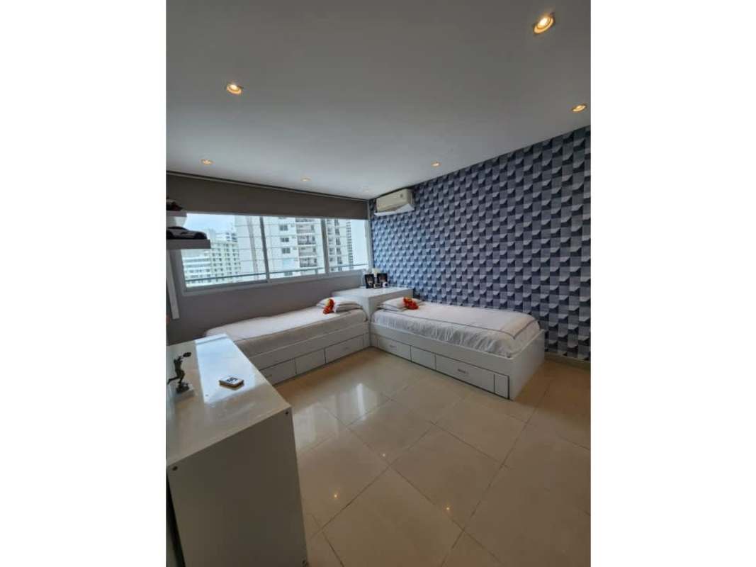 Kids bedroom with blue accent wall city views PH Vista del Sol Punta Paitilla Panama