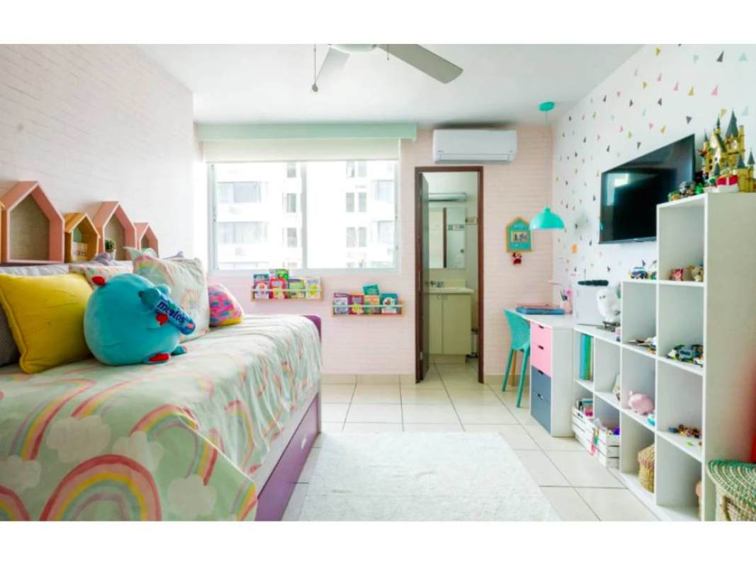 Bright colorful children's bedroom with study area, toys and large window in PH Bahía Obarrio Panama City