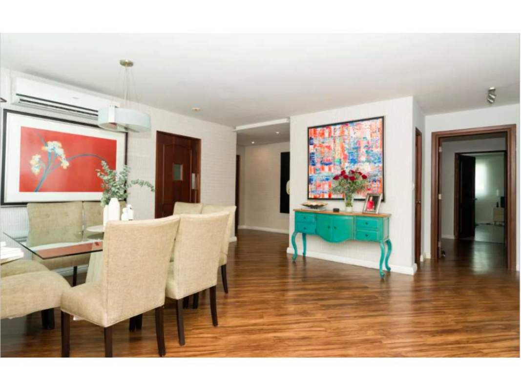 Contemporary dining with glass table upholstered chairs turquoise console PH Bahía Obarrio Panama