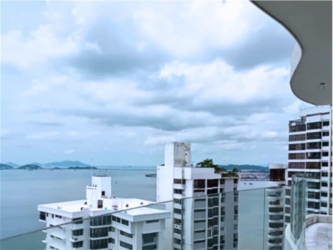 Balcony with glass railing ocean city views PH The Towers Panama