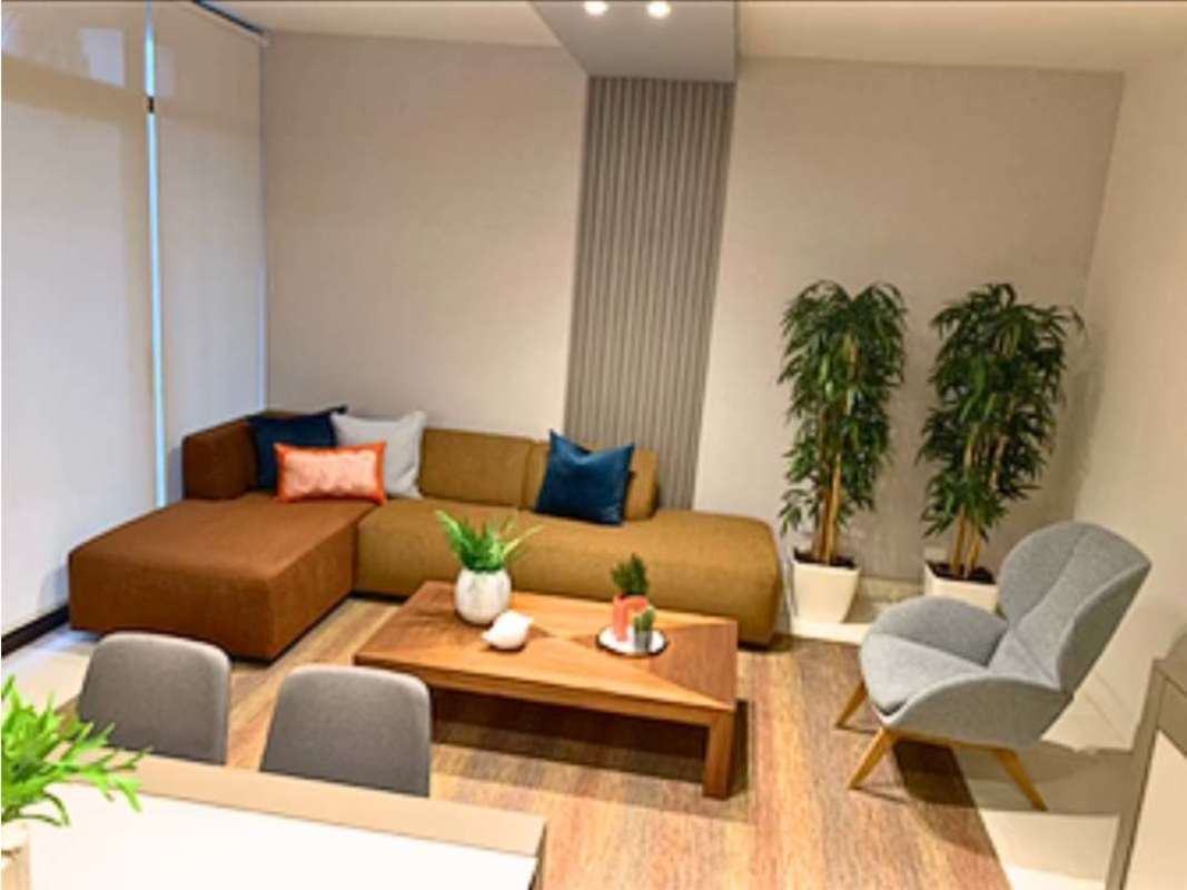 Modern living room with ocean views large windows sectional sofa and wood accents in Mareas Beach Club Coronado Panama