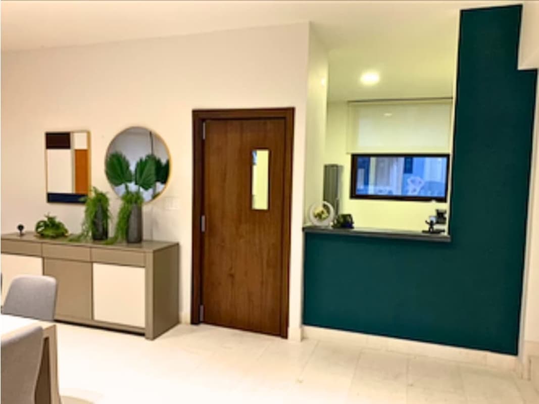 Dining area with pass-through window to kitchen wood accents plants and wall decor Mareas Beach Club Coronado Panama