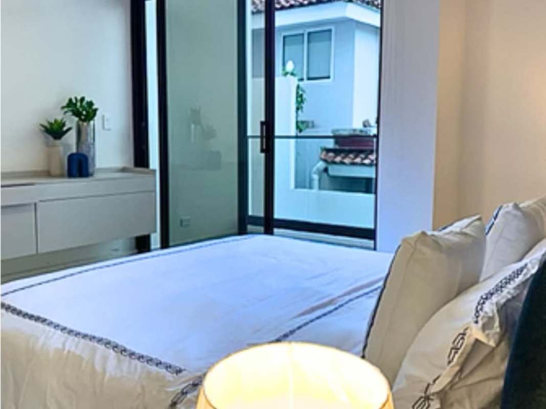 Bedroom with sliding glass balcony doors wood floor decor at Mareas Beach Club Coronado Panama