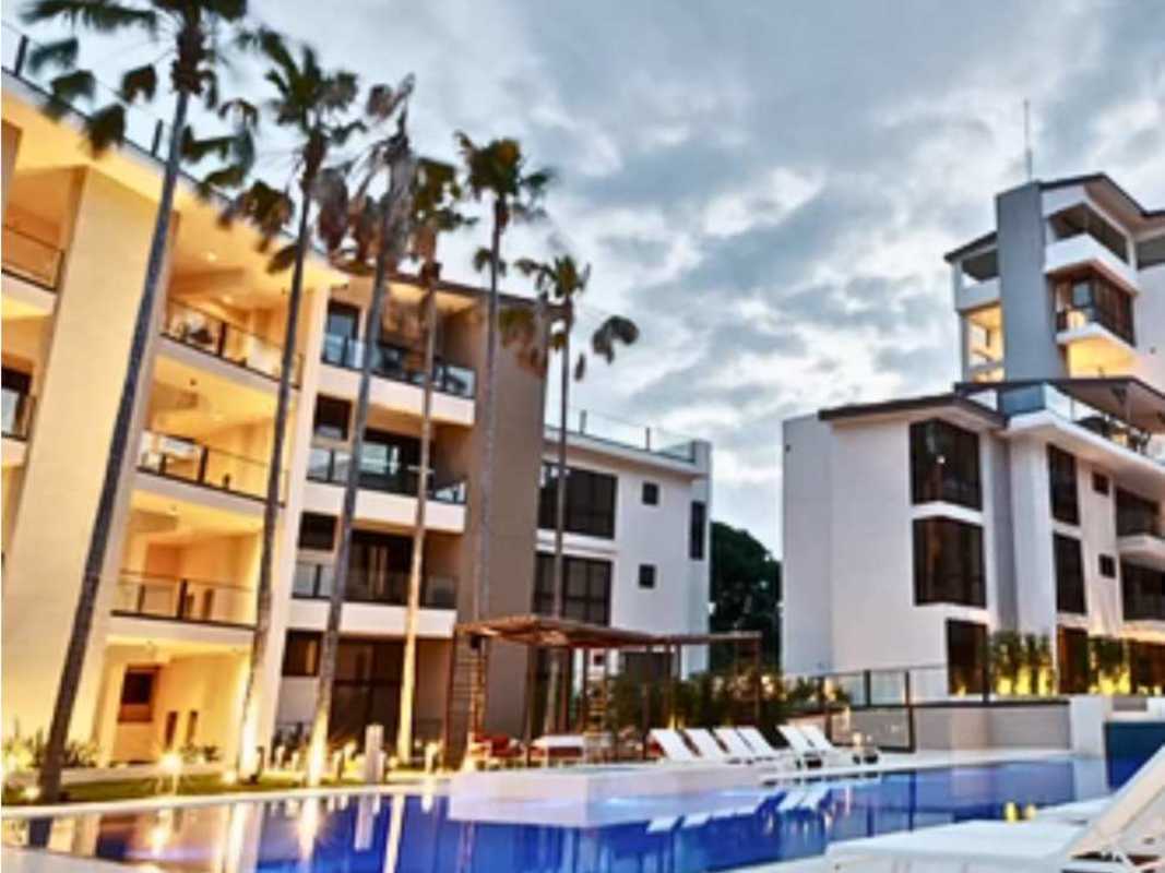 Swimming pool palm trees beachfront buildings Mareas Beach Club Coronado Panama dusk