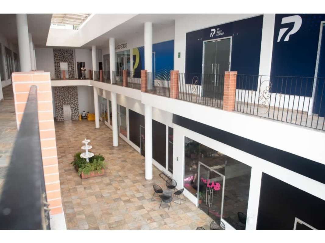 Indoor two-level shopping corridor with skylight and fountain at Plaza Bella Vista Panama