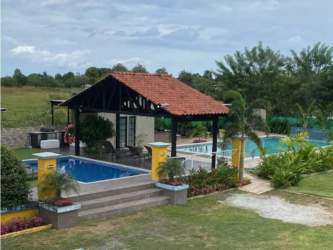 Swimming pool with pavilion and landscape tropical gardens at Airbnb property Río Hato Panama