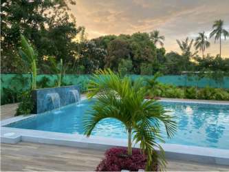 Outdoor pool and shaded pavilion within fenced tropical compound Airbnb income rental Panama