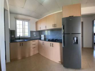 Modern outdoor pool with waterfall feature lush tropical garden Airbnb rental Panama