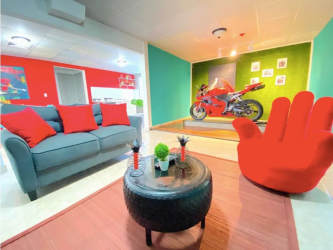 Colorful eclectic living room with motorcycle display and modern art at Río Hato Airbnb property Panama
