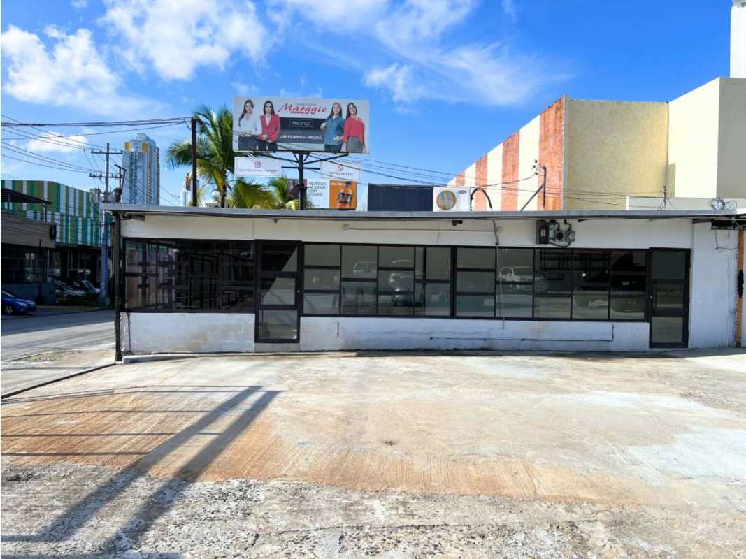 Street facing side of commercial plaza with access points and glass façade Panama City