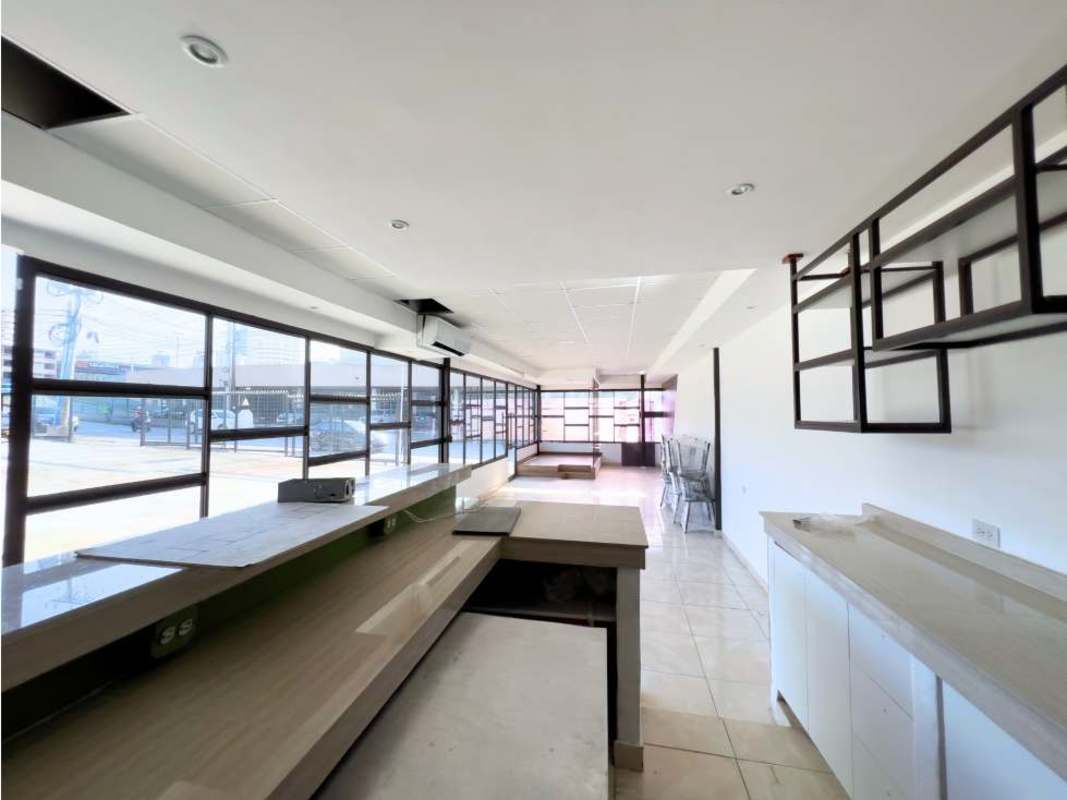 Spacious commercial interior space with floor-to-ceiling windows and counter Vía Porras Panama