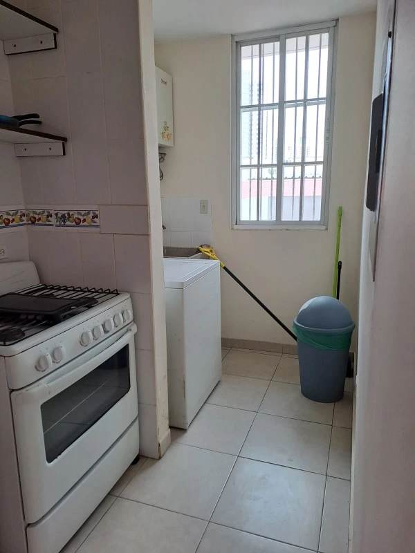 Compact kitchen with gas stove refrigerator white cabinets PH Lefevre Garden Panama City