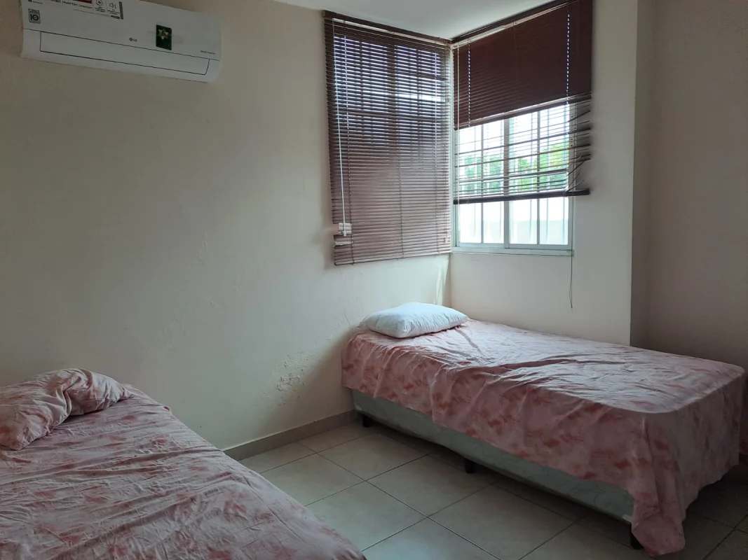 Bedroom with twin beds white wardrobe blinds PH Lefevre Garden Panama