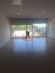 Inside commercial retail space looking through glass storefront at Plaza Central Las Uvas Panama