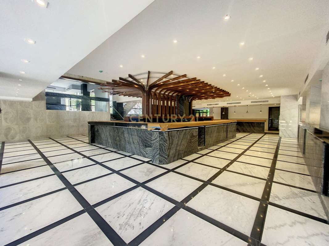 Double-height marble reception lobby with glass stairs commercial building Obarrio Panama