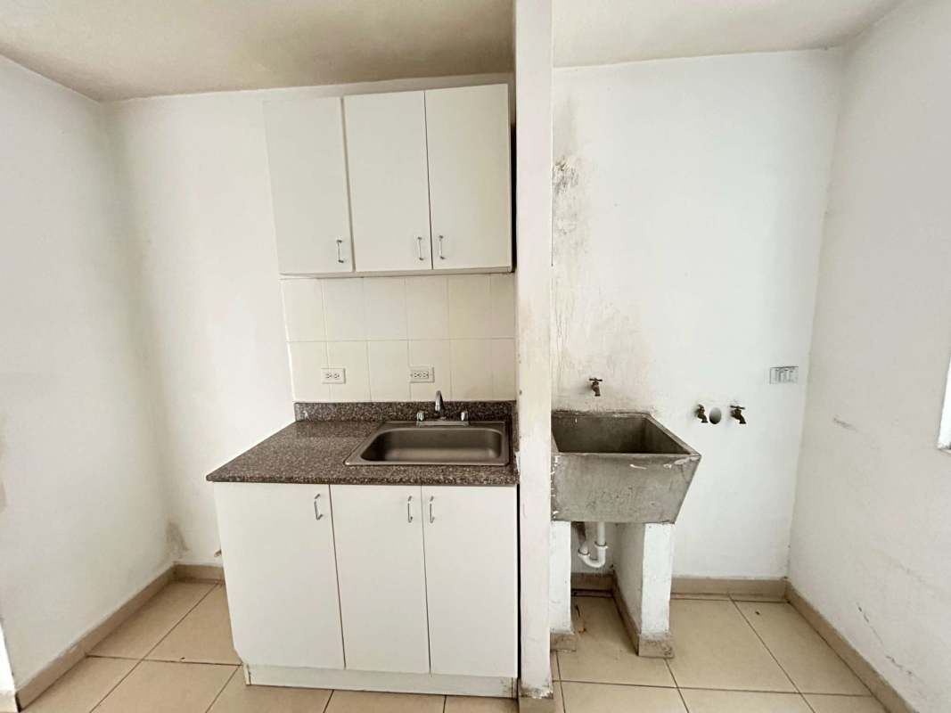 Bright bathroom with blue mosaic-tiled shower, pedestal sink and window in PH Mystic Village Don Bosco Panama