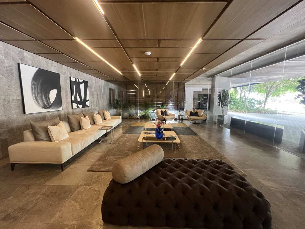 Luxury rooftop swimming pool with waterfall edge, sun loungers, lush landscaping in PH Allegra