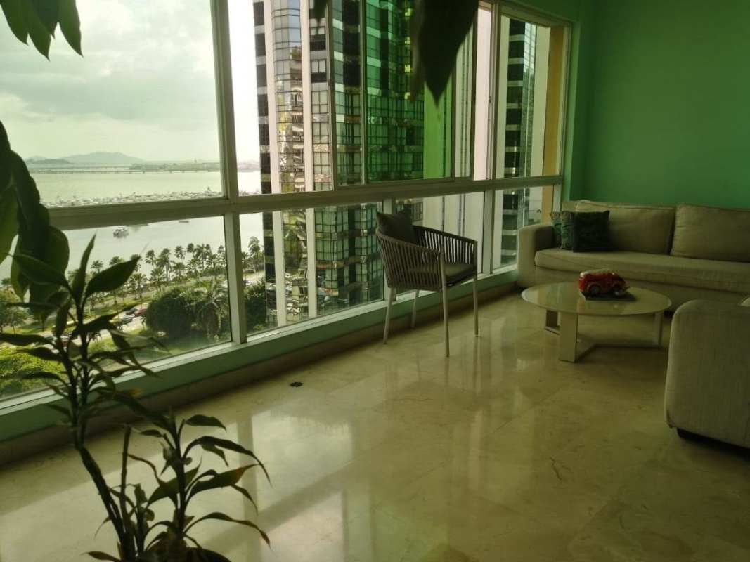 Living room with floor-to-ceiling windows and ocean view at PH BICSA condo Panama