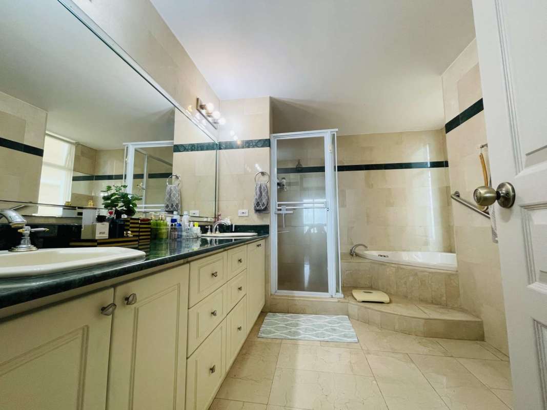 Spa bathroom with double granite vanity and walk-in glass shower at PH BICSA Panama