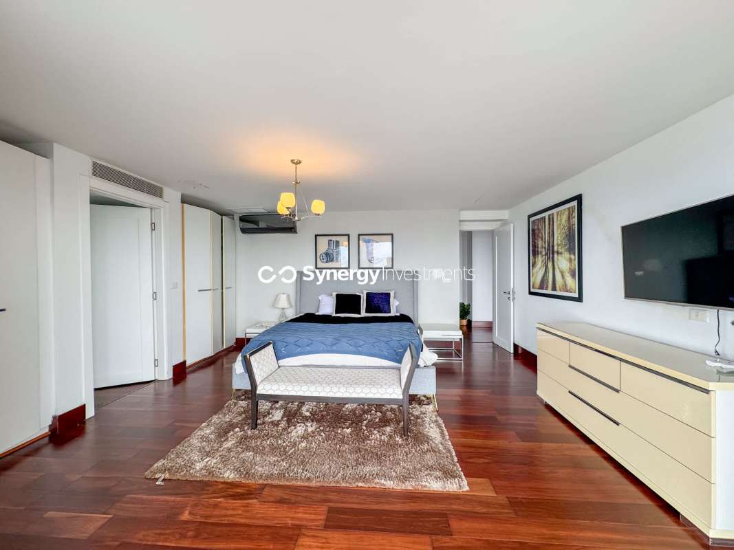 Spacious luxury bathroom with dual sinks and glass shower in Yoo Panama penthouse