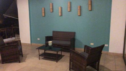 Outdoor covered balcony with dining area and stone accent wall Punta Barco Resort Panama