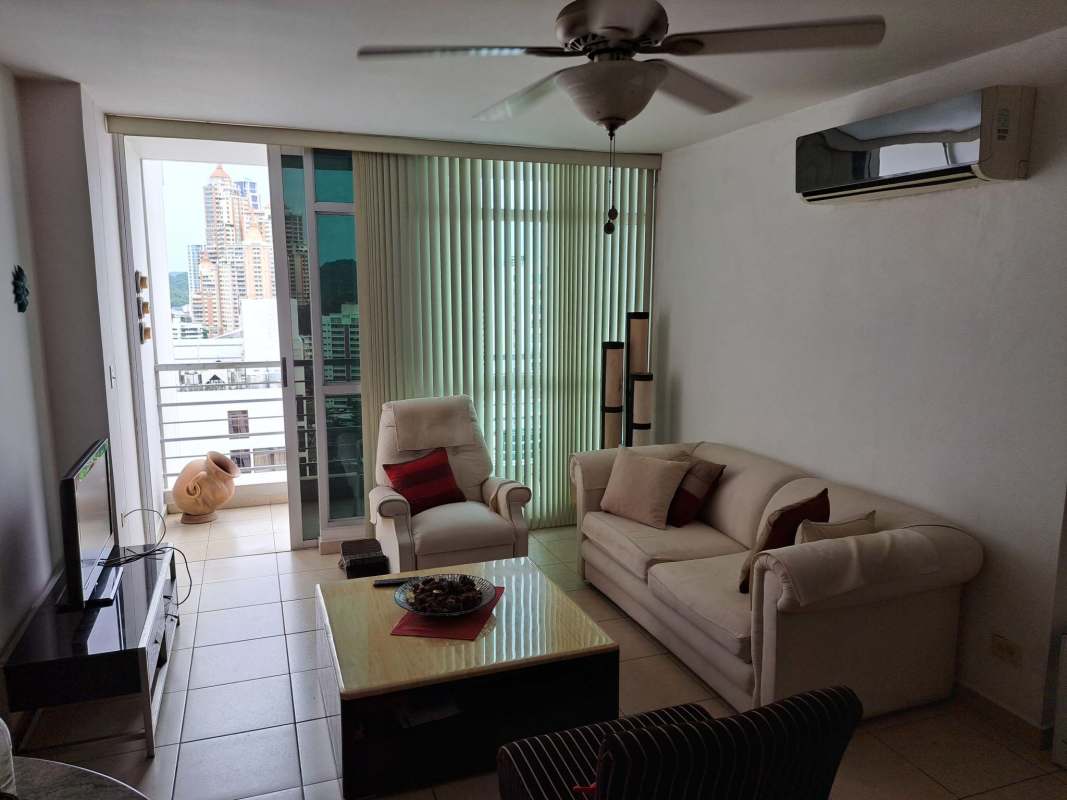 Modern furnished living room with access to balcony with city views in PH El Cangrejo Tower Panama City