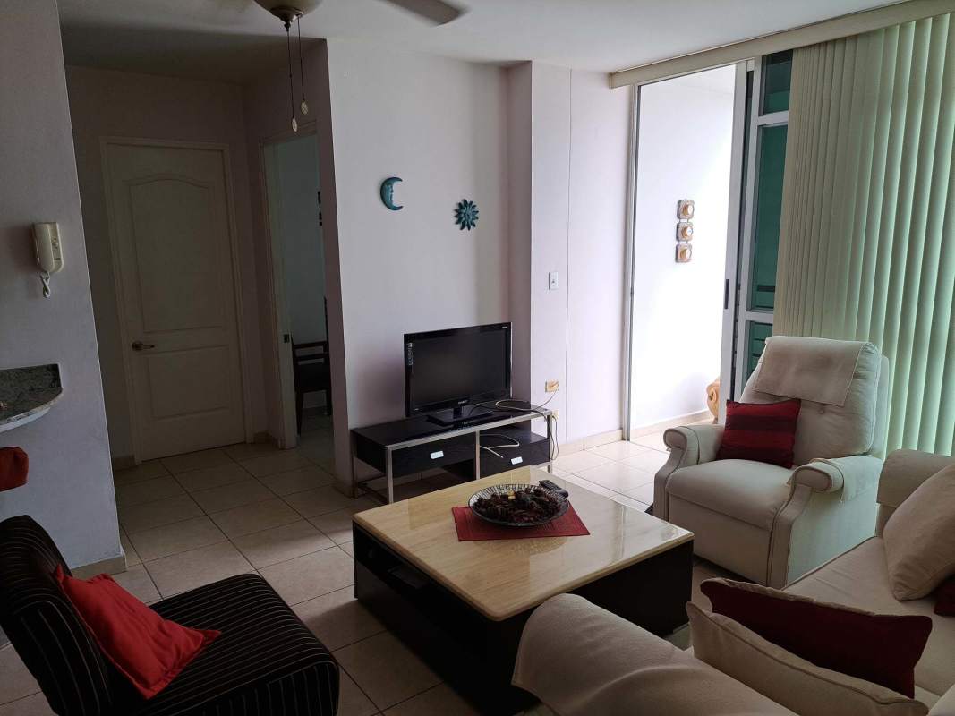 Living area with sofa, armchair, balcony access, and city views in PH El Cangrejo Tower Panama