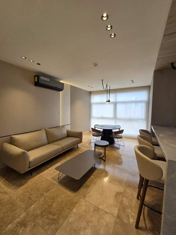 Minimalist bedroom with marble accent, upholstered bed, and city view at PH Ocean Club Punta Pacifica Panama