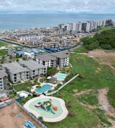 Modern kitchen with granite counter appliances stacked washer dryer Playa Caracol Panama