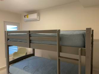 Minimalist kids bedroom with bunk bed AC coastal condo Playa Caracol Panama