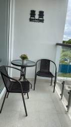 Oceanview glass-railed balcony with outdoor furniture Playa Caracol Chame Panama
