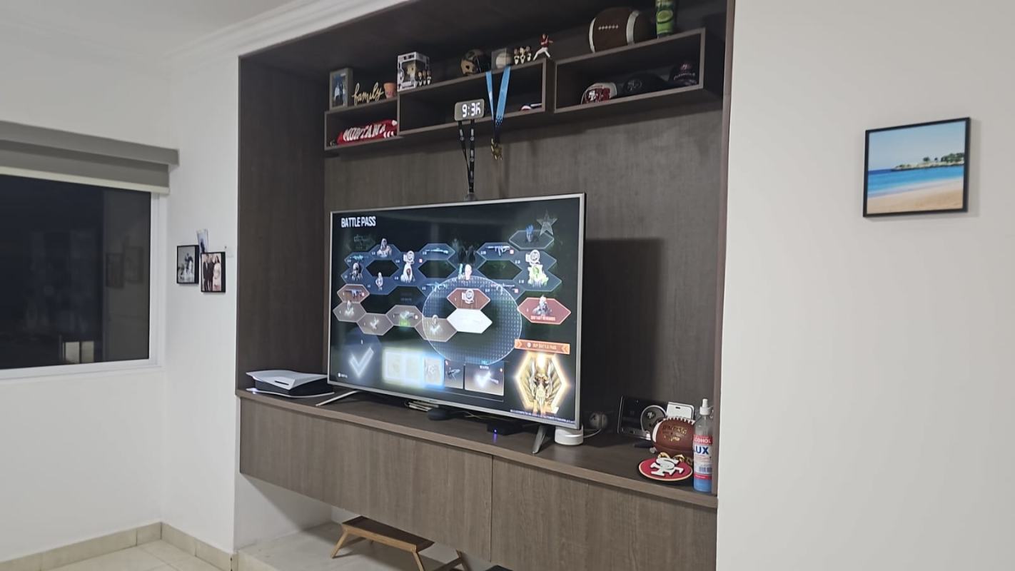 Entertainment room with media center, wood shelving and city views PH Metropolitan Park Obarrio Panama