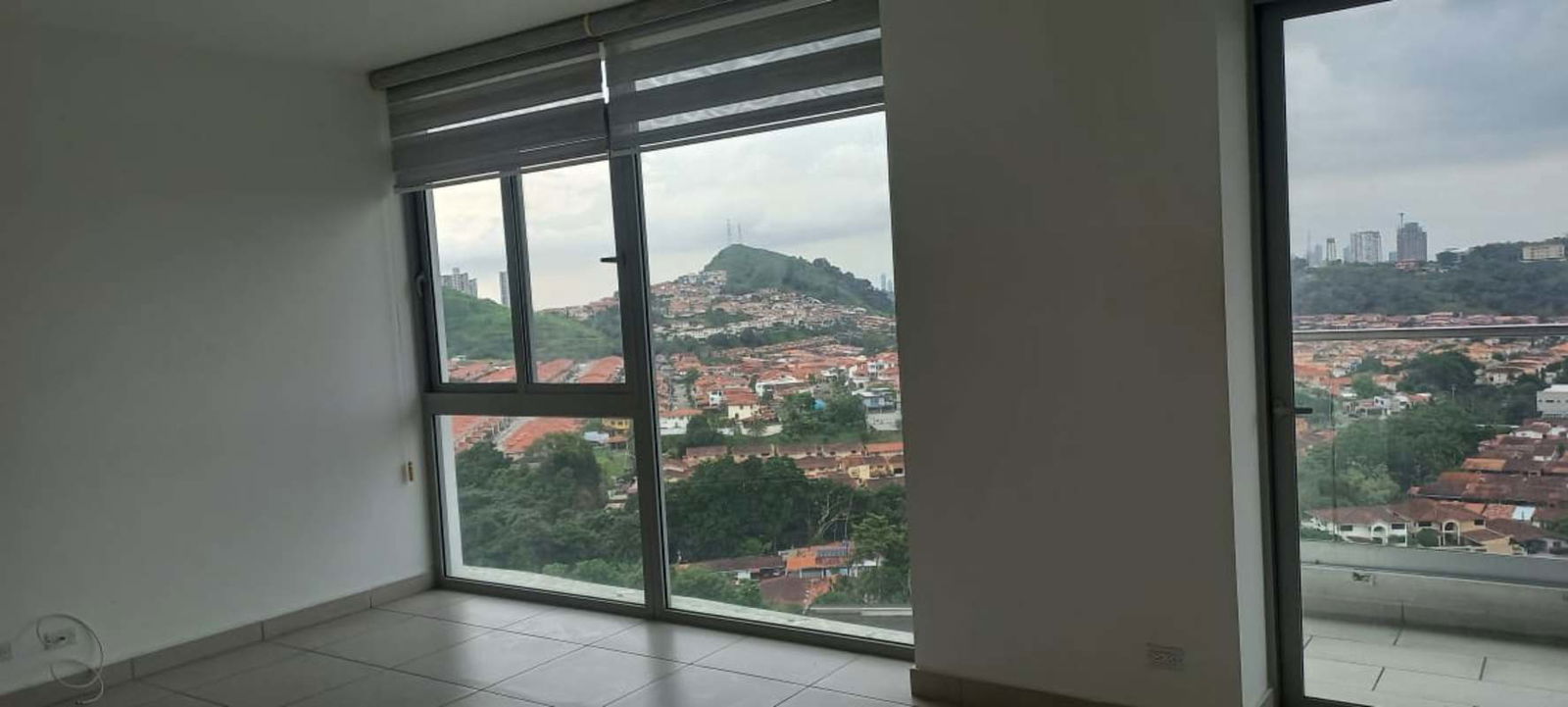 Modern living room with floor to ceiling windows and city view in Altos de Panama