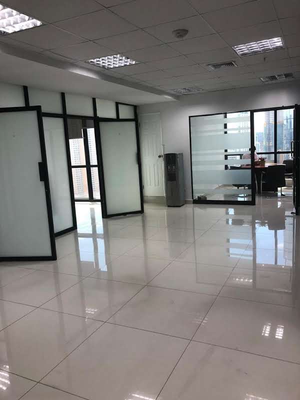 Modern reception area with glass partitions sofas and reception desk at PH Tower Financial Center Panama