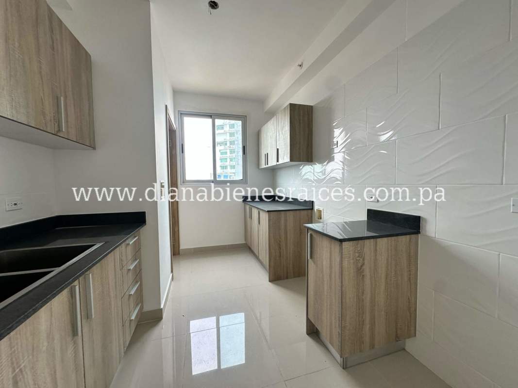Kitchen with wood cabinets, granite countertops and large window PH Hato Pintado Panama