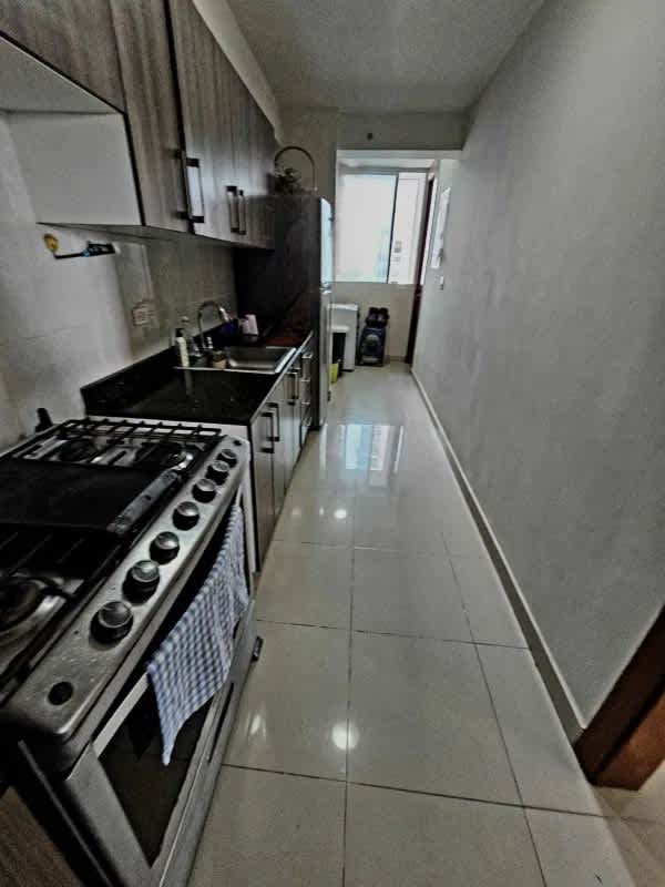 Two bathrooms with glass shower cabins and granite counters Residencias del Sol Carrasquilla