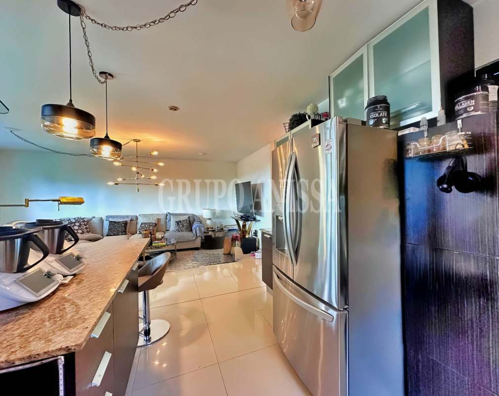 Kitchen with granite countertops, breakfast bar, appliances in PH Albrook Gardens Panama City