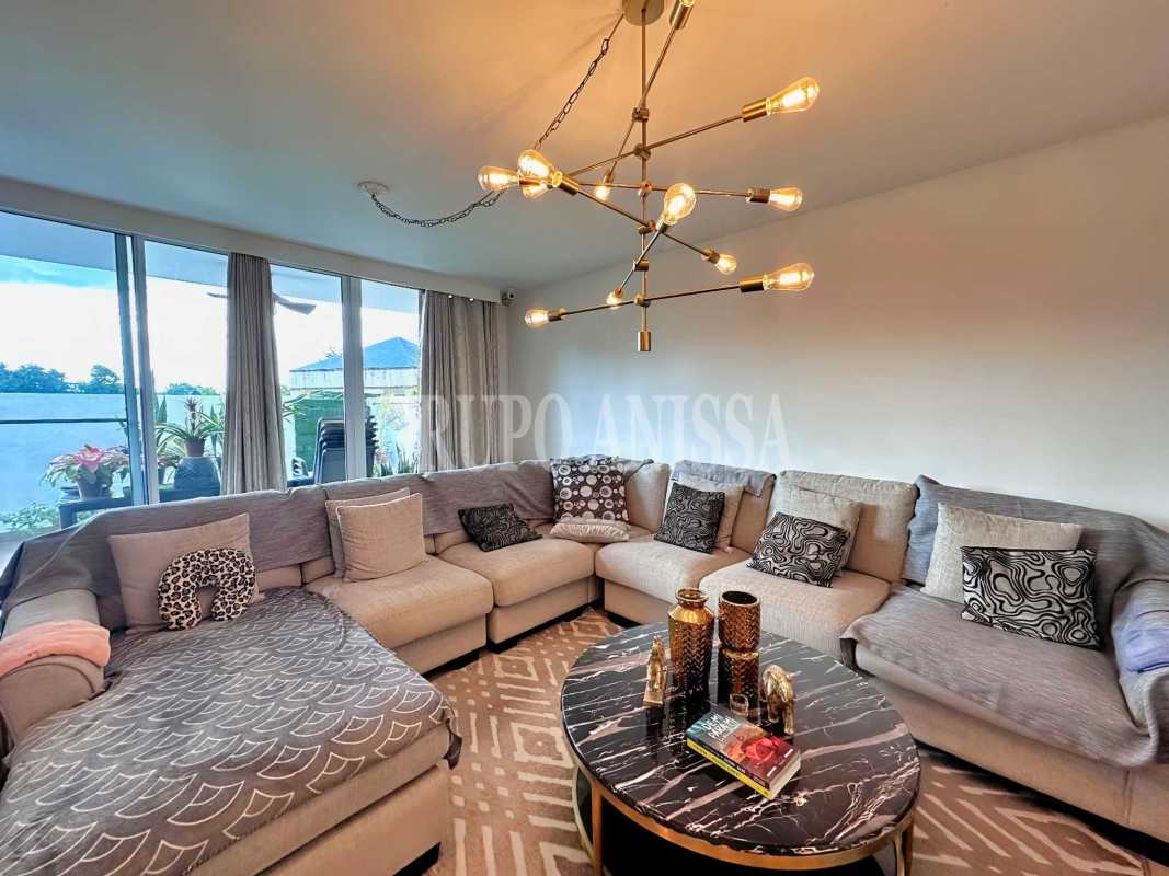 Contemporary living room with large windows, ceiling fan and terrace access in Albrook Panama