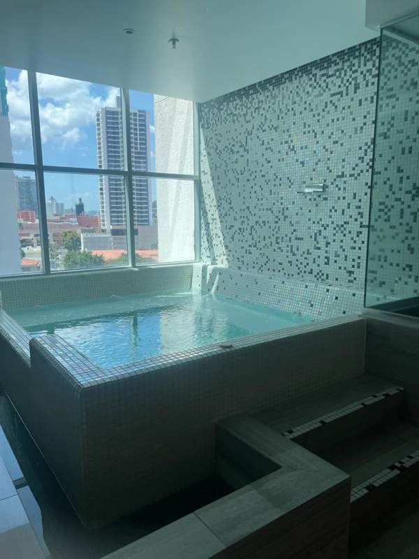 Modern gym with large windows and equipment inside PH Dinasty Bella Vista Panama