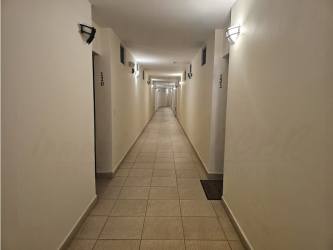 Long hallway with tile floors in PH Soleo Panama apartment building Arraijan