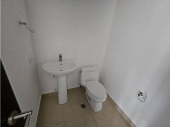 Simple clean minimalist bathroom with pedestal sink and toilet in PH Soleo Panama Pacifico